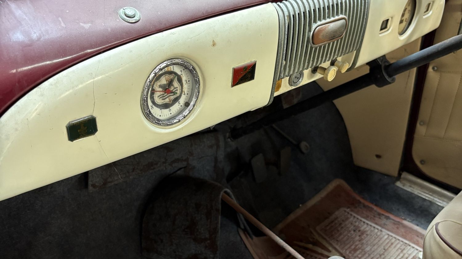 The cream dashboard of the Morris Minor with its chrome-bezelled clock and ribbed centre panel